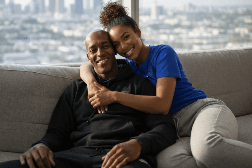 Peter and his wife sitting together in their London apartment, reflecting the quiet resilience of migration.