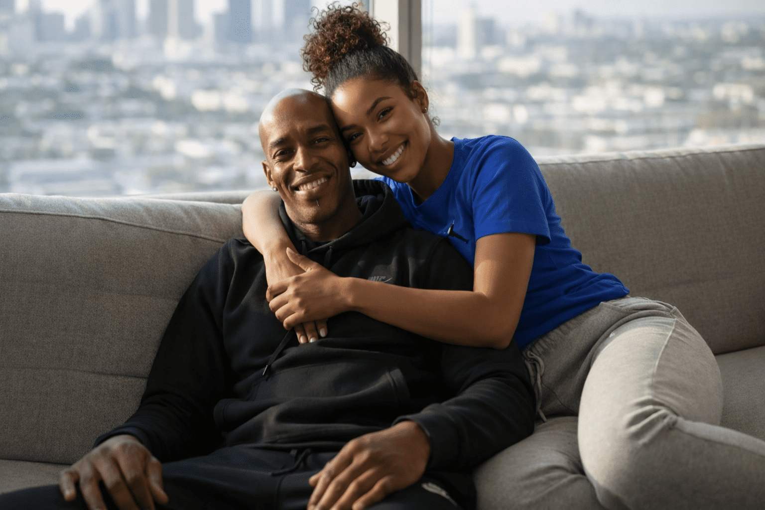 Peter and his wife sitting together in their London apartment, reflecting the quiet resilience of migration.