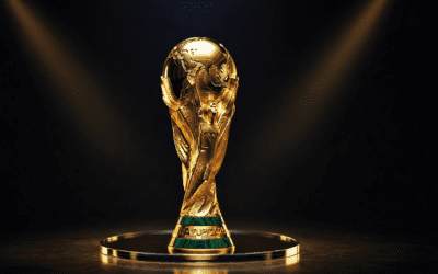 A golden FIFA World Cup trophy standing on a reflective pedestal under dramatic lighting, representing Africa’s first World Cup and the continent’s shared sense of pride and visibility.