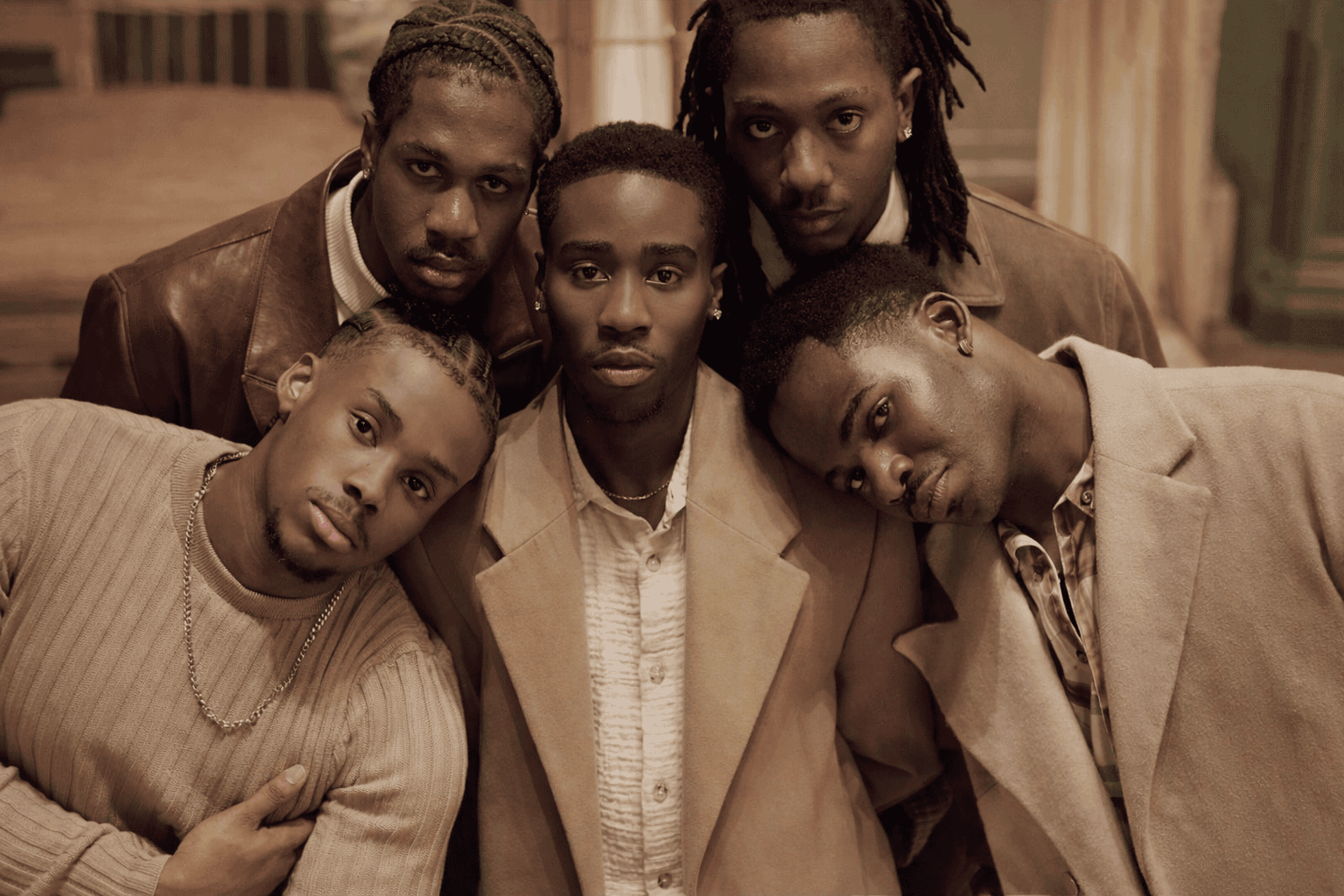 Five Black men dressed in coordinated neutral tones symbolising unity, mentorship and the African collective that shapes responsible fatherhood.