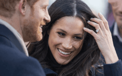 Prince Harry and Meghan Markle smiling outdoors, representing their decision to move back to Britain with their children.