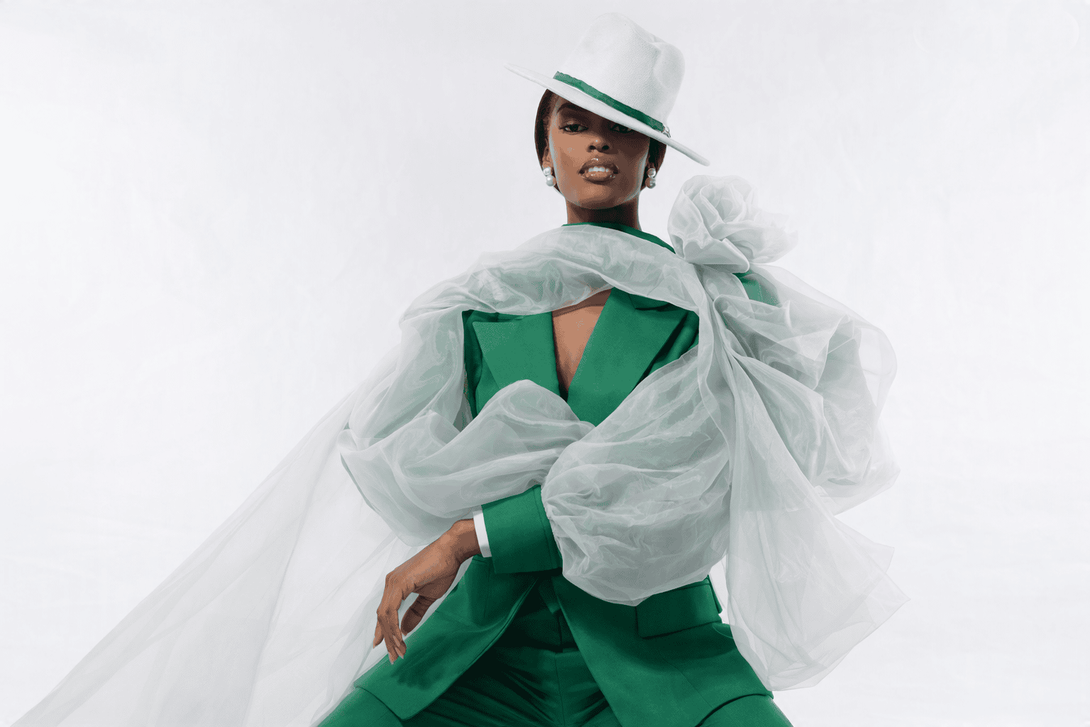 Portrait of Chidimma Adetshina wearing a green suit with white sheer overlay, symbolising resilience and identity amid her South African deportation case.