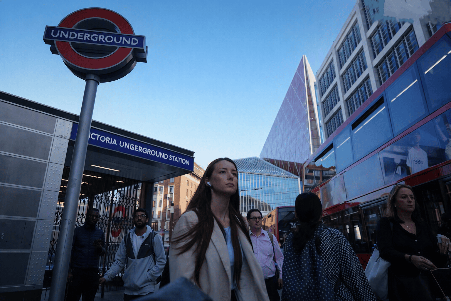 “Commuters outside Victoria Underground Station in London, representing UK workers facing high rental costs.”